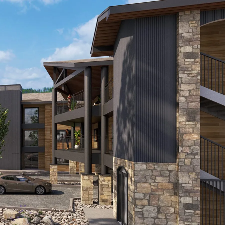 The building’s corner in the final scheme: the existing stone base, slate-grey vertical siding above, timber-framed balconies