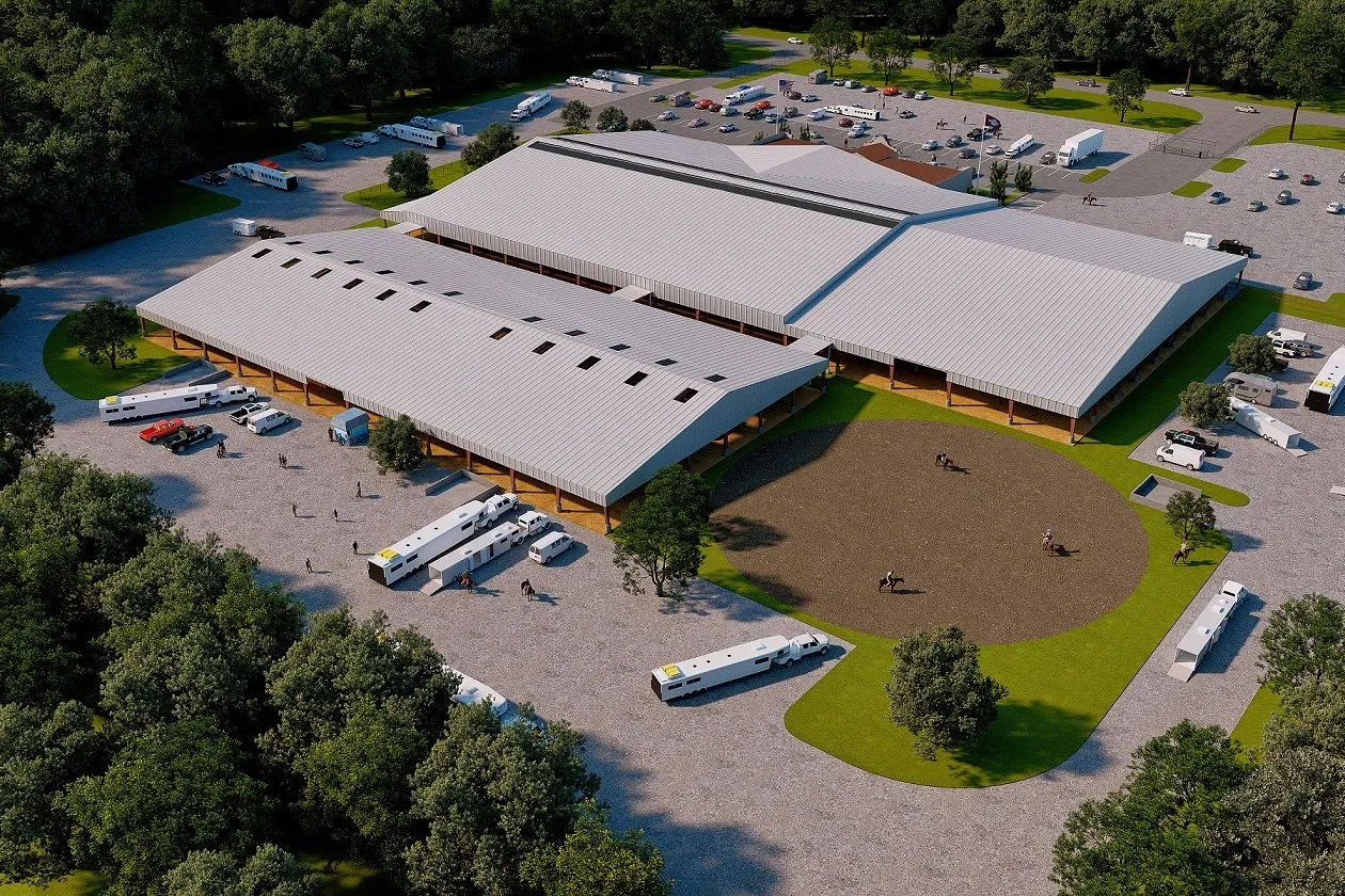 Photoreal aerial view of an equestrian arena facility with barns, riding rings, trailers and parking